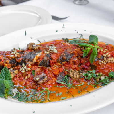 Oven baked gilthead seabream with red sauce and pine nuts - Chez Toni