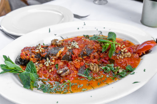 Oven baked gilthead seabream with red sauce and pine nuts - Chez Toni
